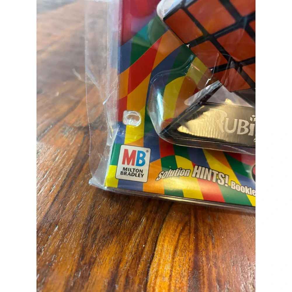 Milton Bradley Rubiks Cube 3x3 Puzzle with Stand and Booklet 54033 New Sealed